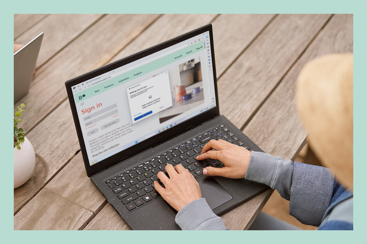 Kobieta korzysta z laptopa i wykorzystuje wbudowane opcje zabezpieczeń systemu Windows 11.